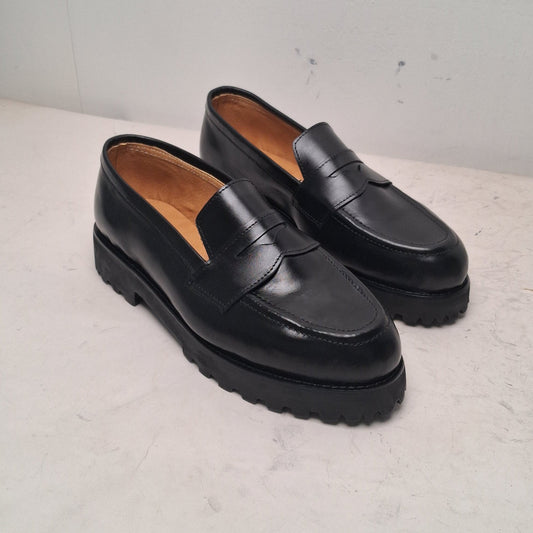 Pair of black loafers on a light gray background